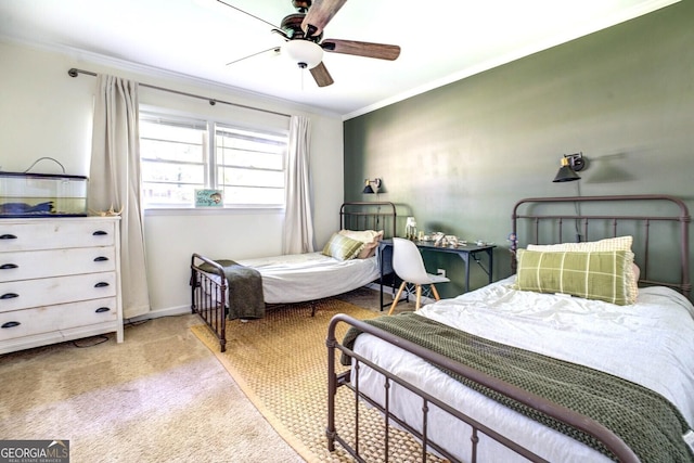 bedroom with crown molding, a ceiling fan, and carpet flooring