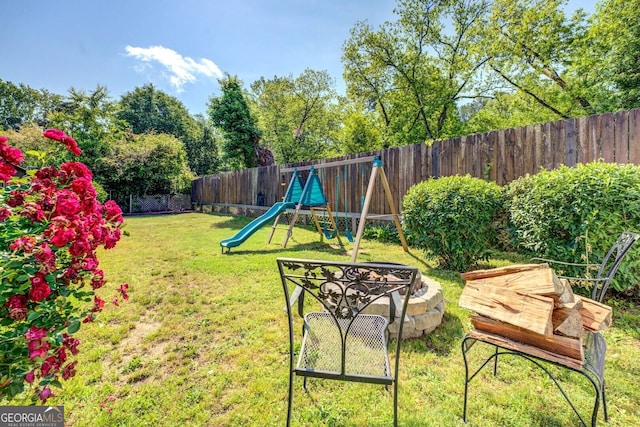 view of yard with a fenced backyard and a playground