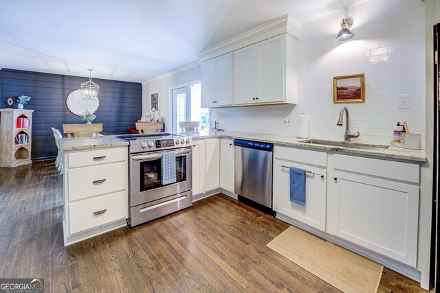 5327 David Cir SE, Covington, GA 30014 - kitchen with appliances with stainless steel finishes, a sink, a peninsula, dark wood finished floors, and white cabinets