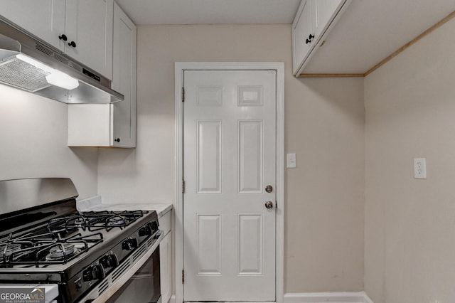 kitchen with baseboards, stainless steel range with gas cooktop, light countertops, white cabinetry, and under cabinet range hood