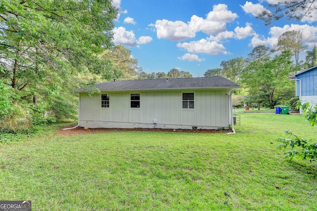 back of house featuring a yard and crawl space