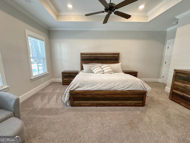 carpeted bedroom featuring a tray ceiling, crown molding, and recessed lighting