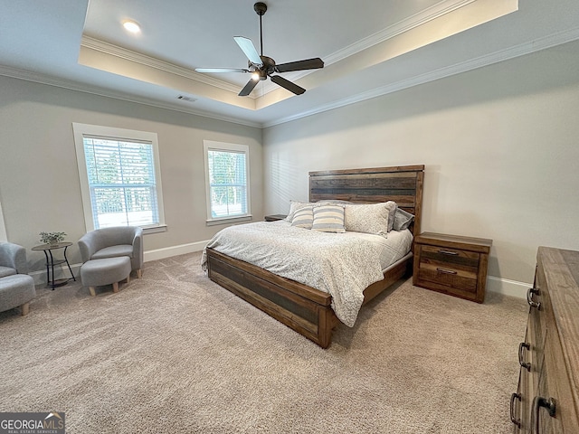 bedroom with crown molding, carpet, a tray ceiling, and visible vents