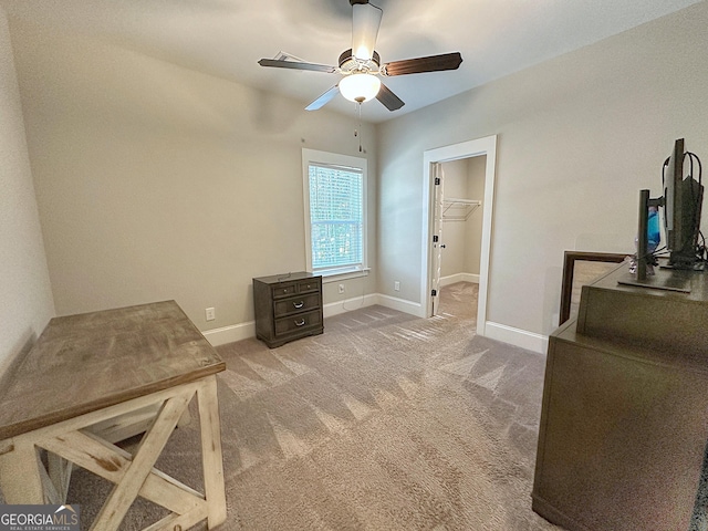 interior space featuring baseboards, a ceiling fan, and carpet floors