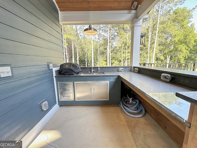 unfurnished sunroom with a sink and plenty of natural light