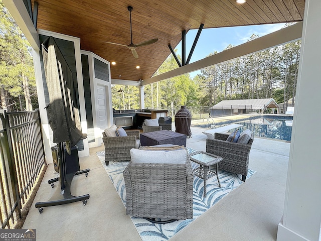 view of patio / terrace featuring ceiling fan, an outdoor hangout area, fence, and an outdoor pool
