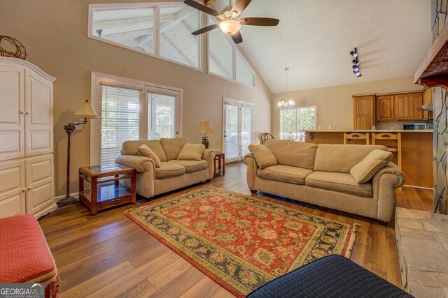 2787 Turtle Cove Trwy, Monticello, GA 31064 - living room featuring high vaulted ceiling, ceiling fan, a chandelier, and light wood-style floors