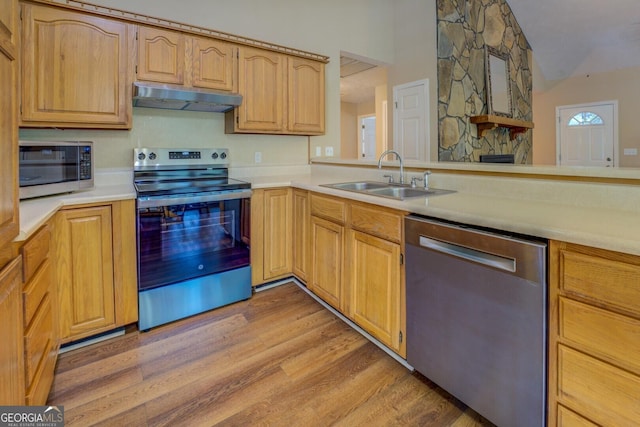 2787 Turtle Cove Trwy, Monticello, GA 31064 - kitchen featuring appliances with stainless steel finishes, under cabinet range hood, a sink, light wood-style flooring, and light countertops