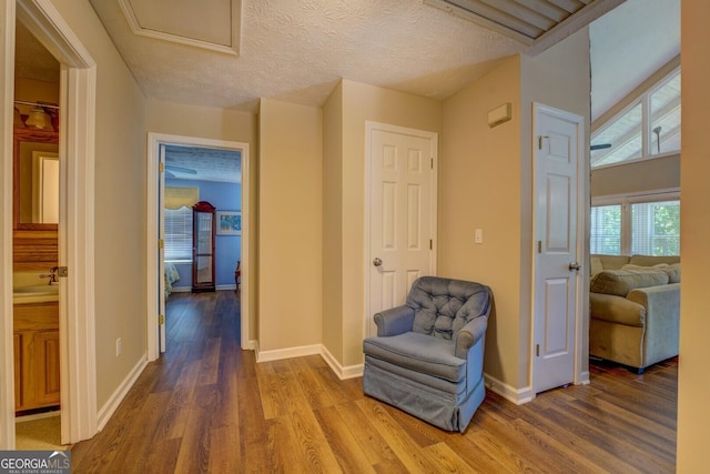 2787 Turtle Cove Trwy, Monticello, GA 31064 - corridor featuring wood finished floors, baseboards, attic access, and a textured ceiling
