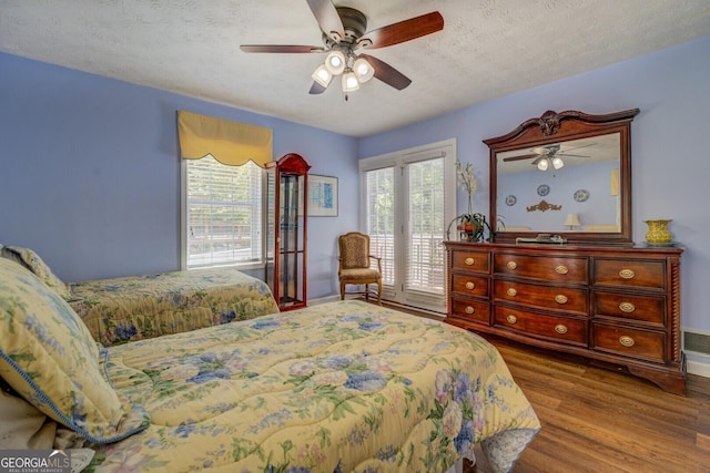 2787 Turtle Cove Trwy, Monticello, GA 31064 - bedroom featuring access to exterior, wood finished floors, a textured ceiling, ceiling fan, and baseboards