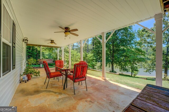 2787 Turtle Cove Trwy, Monticello, GA 31064 - view of patio / terrace with outdoor dining space, ceiling fan, and view of scattered trees
