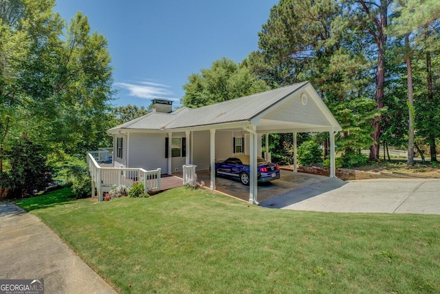 2787 Turtle Cove Trwy, Monticello, GA 31064 - view of front facade featuring driveway, a front yard, a chimney, and metal roof