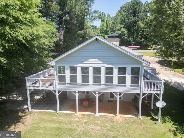 2787 Turtle Cove Trwy, Monticello, GA 31064 - back of property with a chimney, a patio area, a deck, and a yard