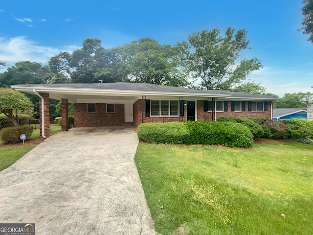 ranch-style house with a carport, concrete driveway, a front lawn, and brick siding