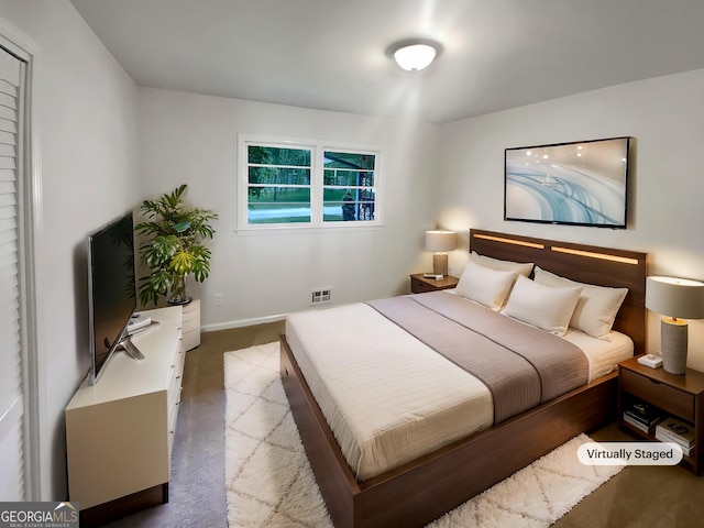 carpeted bedroom featuring baseboards and visible vents