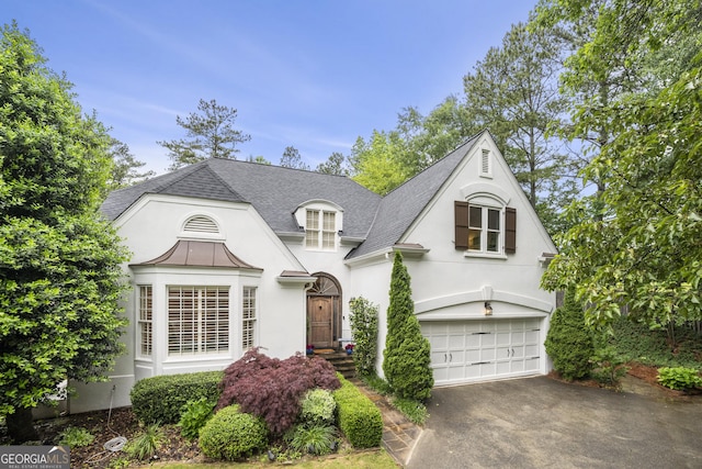 4503 Woodhaven NE, Marietta, GA 30067 - french country home with stucco siding, an attached garage, asphalt driveway, and roof with shingles