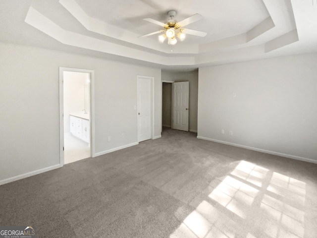 30 Trelawney Ct, Covington, GA 30016 - unfurnished bedroom featuring baseboards, carpet, ensuite bath, and a tray ceiling