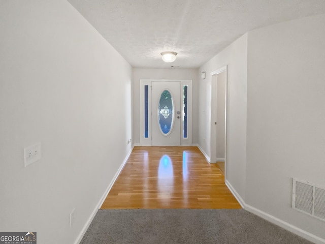 30 Trelawney Ct, Covington, GA 30016 - doorway with baseboards, visible vents, and light wood-style floors