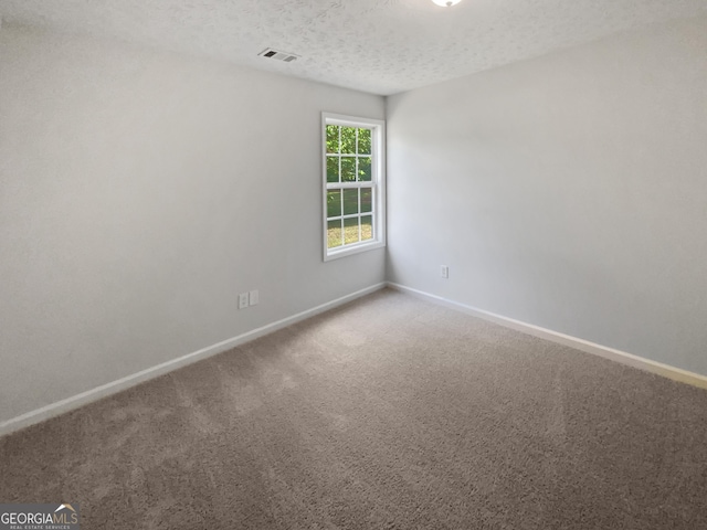 30 Trelawney Ct, Covington, GA 30016 - carpeted empty room featuring a textured ceiling, baseboards, and visible vents