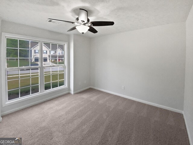 30 Trelawney Ct, Covington, GA 30016 - empty room with a textured ceiling, carpet, a ceiling fan, baseboards, and visible vents