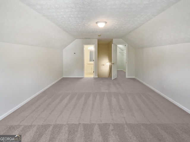 30 Trelawney Ct, Covington, GA 30016 - additional living space with carpet floors, baseboards, and vaulted ceiling