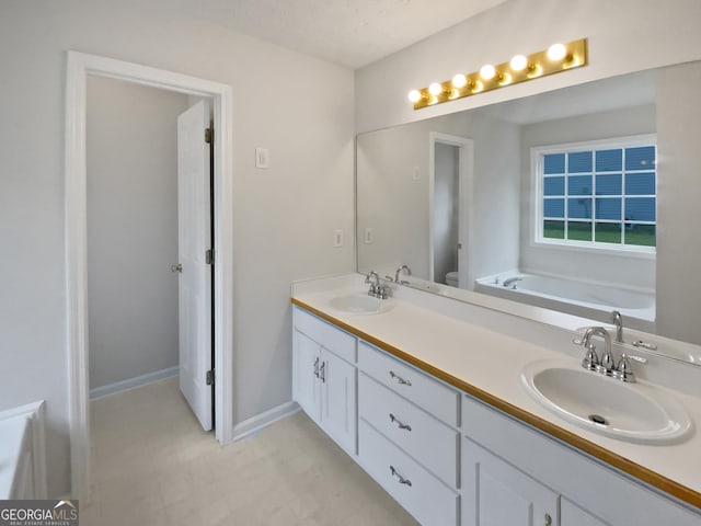 30 Trelawney Ct, Covington, GA 30016 - bathroom with double vanity, a sink, and a garden tub