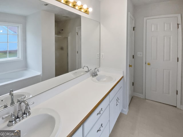 30 Trelawney Ct, Covington, GA 30016 - bathroom featuring double vanity, a sink, and a stall shower