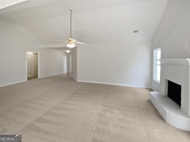 30 Trelawney Ct, Covington, GA 30016 - unfurnished living room featuring a ceiling fan, light colored carpet, visible vents, a brick fireplace, and high vaulted ceiling