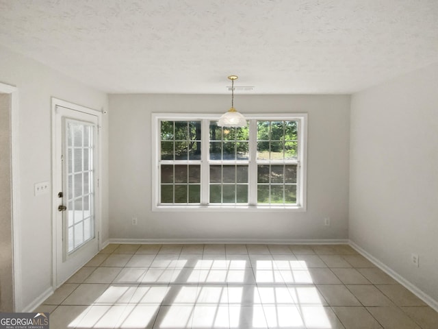30 Trelawney Ct, Covington, GA 30016 - unfurnished dining area featuring light tile patterned flooring, baseboards, visible vents, and a textured ceiling