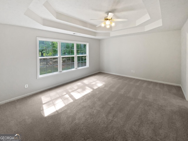 30 Trelawney Ct, Covington, GA 30016 - unfurnished room with baseboards, carpet, a raised ceiling, and ceiling fan