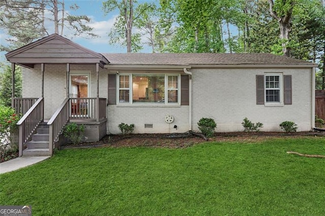 ranch-style house featuring brick siding, crawl space, and a front lawn