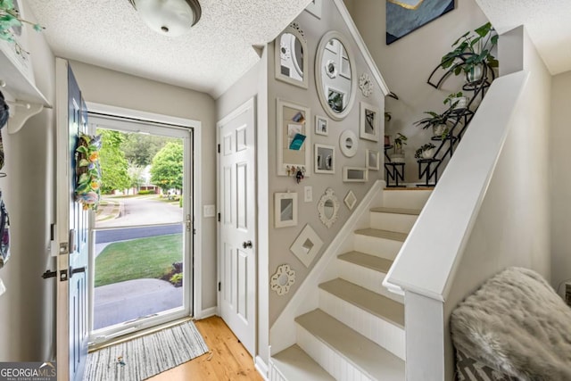 268 Cottonwood Creek Cir, Canton, GA 30114 - foyer with a textured ceiling, wood finished floors, and stairway