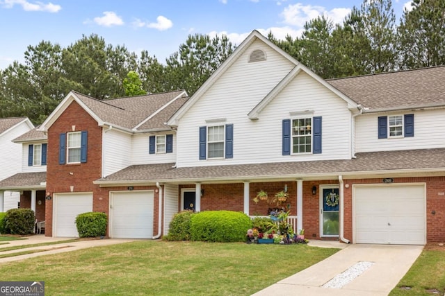 268 Cottonwood Creek Cir, Canton, GA 30114 - traditional-style home featuring roof with shingles, a front lawn, brick siding, a garage, and driveway