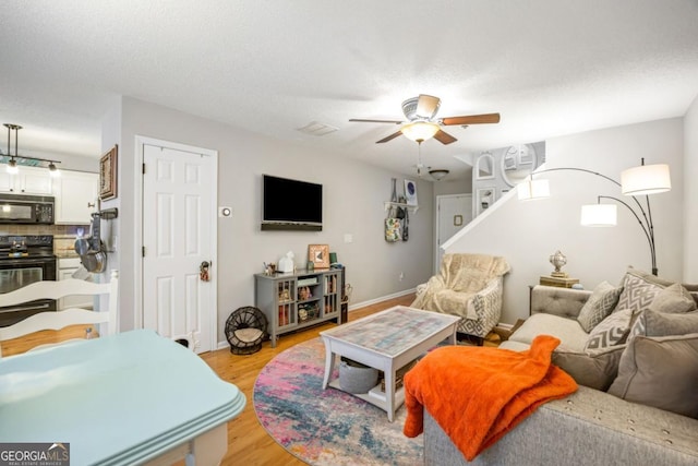 268 Cottonwood Creek Cir, Canton, GA 30114 - living area featuring baseboards, a ceiling fan, and light wood-style flooring
