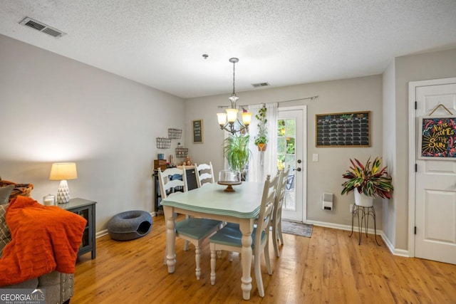 268 Cottonwood Creek Cir, Canton, GA 30114 - dining space featuring visible vents, light wood-style floors, baseboards, and a notable chandelier