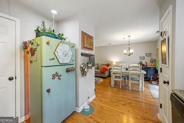 268 Cottonwood Creek Cir, Canton, GA 30114 - kitchen with freestanding refrigerator, a chandelier, light wood finished floors, and dishwasher