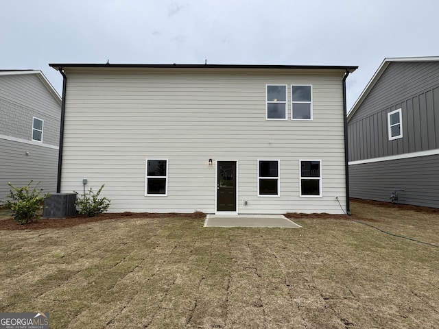 rear view of house with a patio, a lawn, and central air condition unit