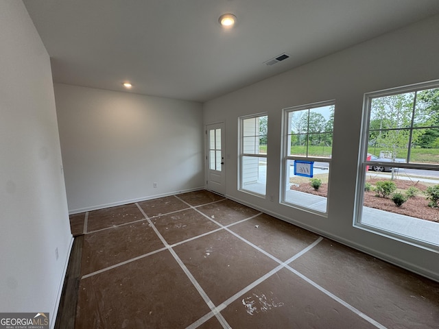 spare room featuring baseboards, recessed lighting, and visible vents