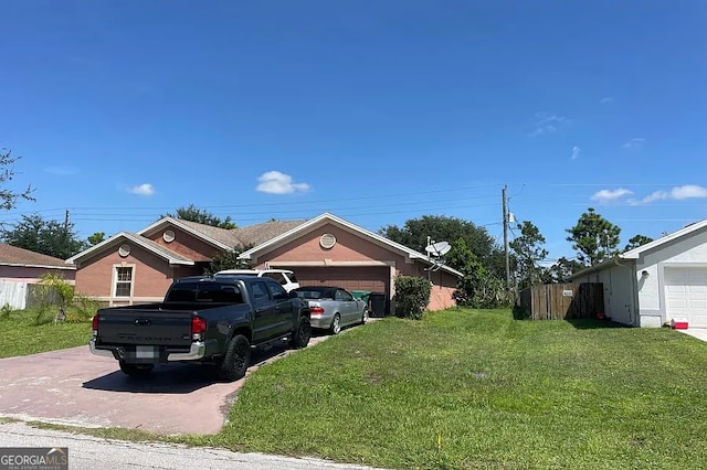 view of front of home featuring a garage, driveway, and a front lawn