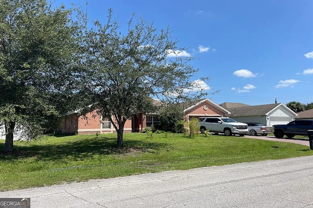 view of front facade with concrete driveway, a front lawn, and a garage