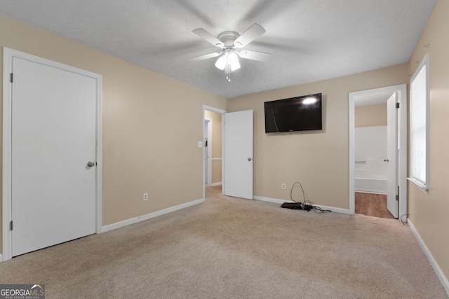 unfurnished bedroom featuring carpet floors, baseboards, and multiple windows