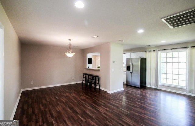 5034 W Ga Highway 292, Collins, GA 30421 - unfurnished living room featuring baseboards, visible vents, and dark wood-type flooring