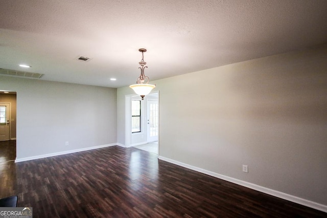 5034 W Ga Highway 292, Collins, GA 30421 - empty room with visible vents, dark wood-style flooring, and a wealth of natural light