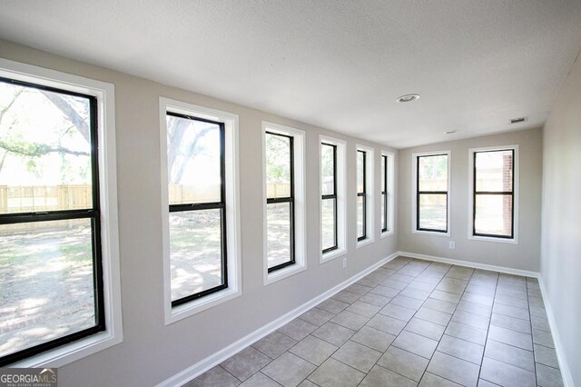 5034 W Ga Highway 292, Collins, GA 30421 - spare room featuring a textured ceiling, baseboards, visible vents, and light tile patterned floors