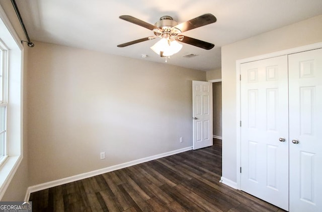 5034 W Ga Highway 292, Collins, GA 30421 - unfurnished bedroom with a ceiling fan, baseboards, dark wood-type flooring, visible vents, and a closet