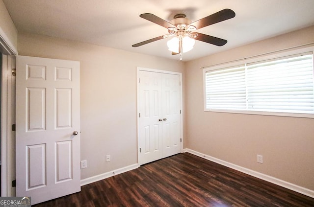 5034 W Ga Highway 292, Collins, GA 30421 - unfurnished bedroom with baseboards, ceiling fan, a closet, and dark wood-style floors