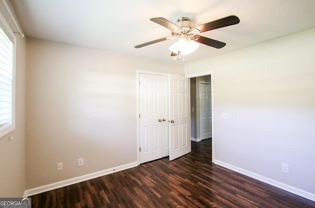 5034 W Ga Highway 292, Collins, GA 30421 - unfurnished bedroom featuring baseboards, multiple windows, a closet, and dark wood-style flooring