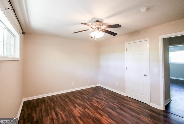 5034 W Ga Highway 292, Collins, GA 30421 - unfurnished bedroom with baseboards, a ceiling fan, and dark wood-style flooring