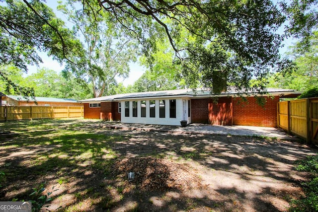 5034 W Ga Highway 292, Collins, GA 30421 - rear view of house featuring brick siding and a fenced backyard