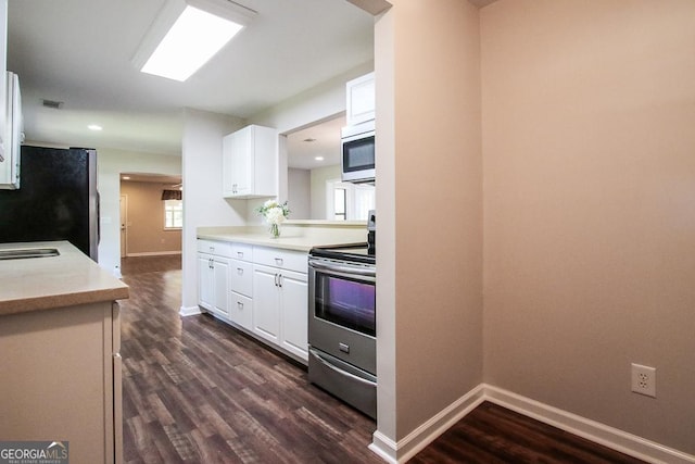 5034 W Ga Highway 292, Collins, GA 30421 - kitchen with baseboards, white cabinets, dark wood-style floors, and stainless steel appliances